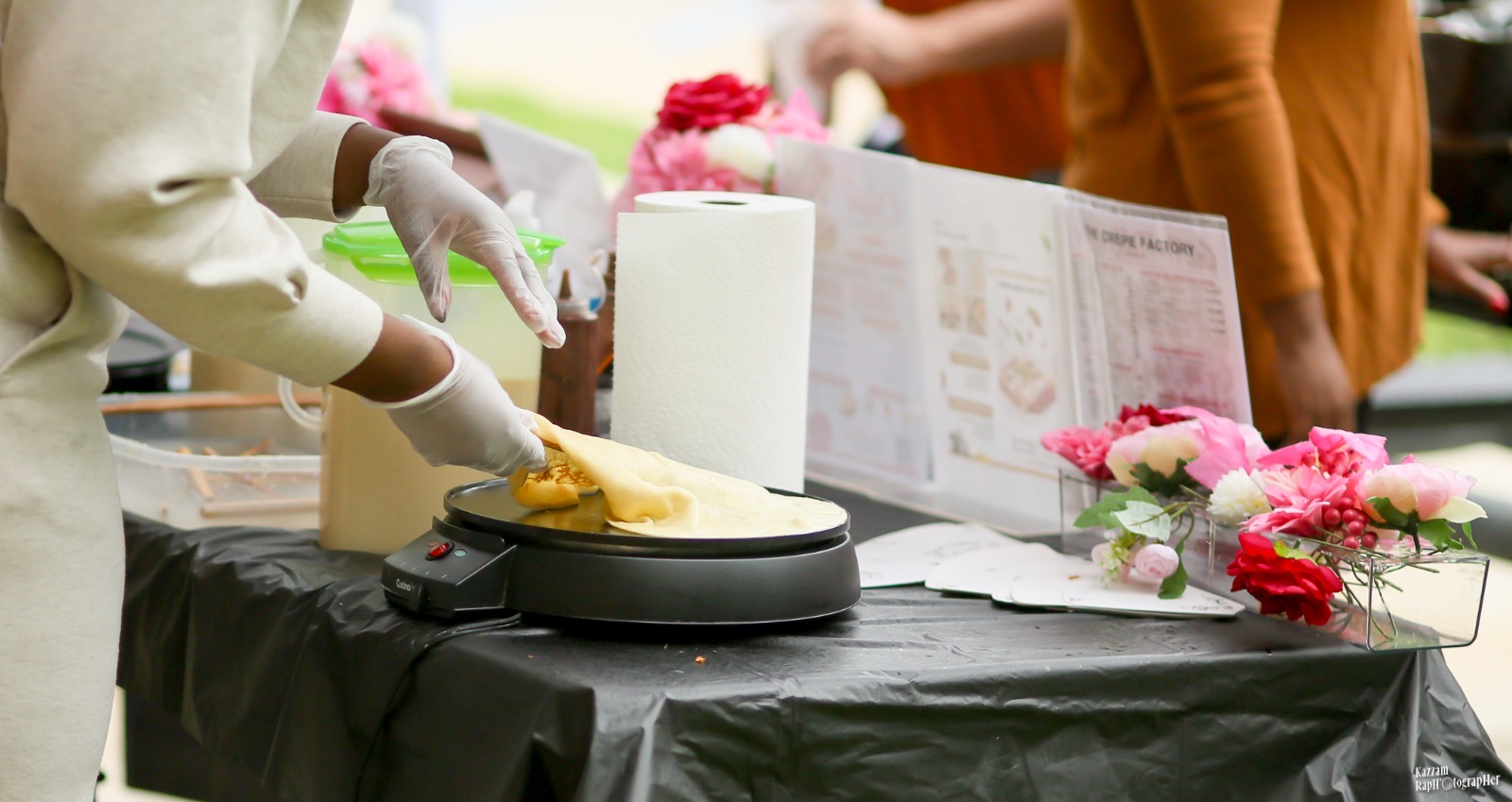 Chef cooking a fresh crêpe on the griddle
